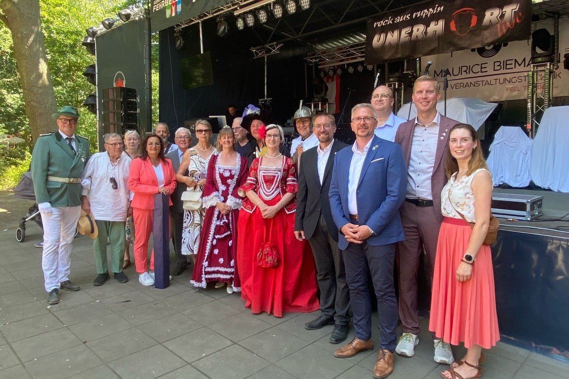 Bürgermeister Carsten Hövekamp (2. v. re.) mit seinem Fehrbelliner Amtskollegen Mathias Perschall (4. v. re.), Ortsvorsteherin Anke Schubert (4. v. li.) sowie weiteren Vertreterinnen und Vertretern beider Städte vor der Bühne im Kurfürstenpark. Foto: privat